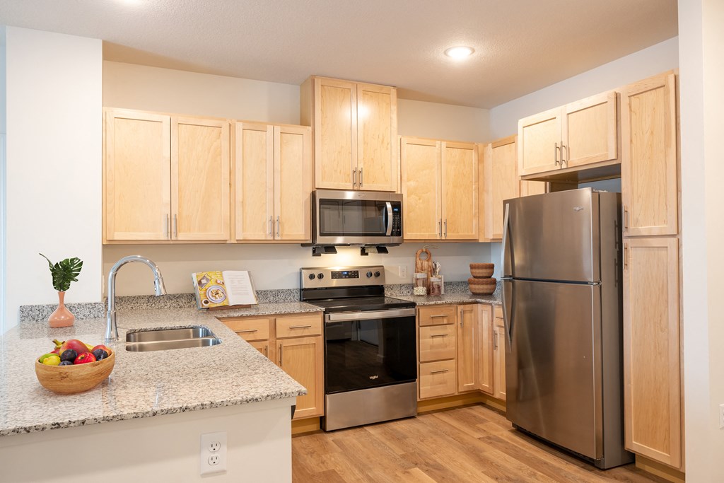 a kitchen with stainless steel appliances and granite counter tops