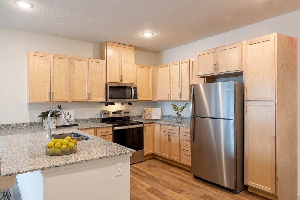 a kitchen with stainless steel appliances and granite counter tops