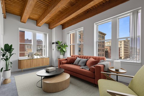 A living room with a red couch and a coffee table.