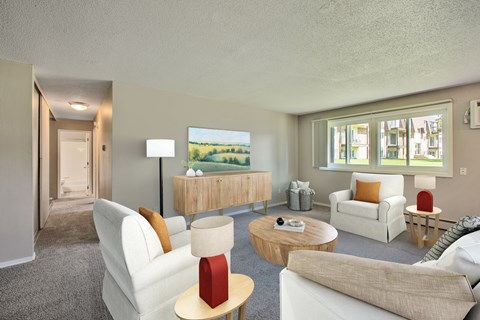 A living room with a white couch, a red lamp, and a painting of a landscape on the wall.