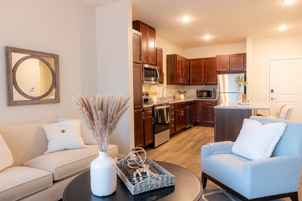 a living room and kitchen with a couch and a table
