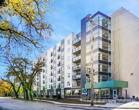an apartment building with a street in front of it