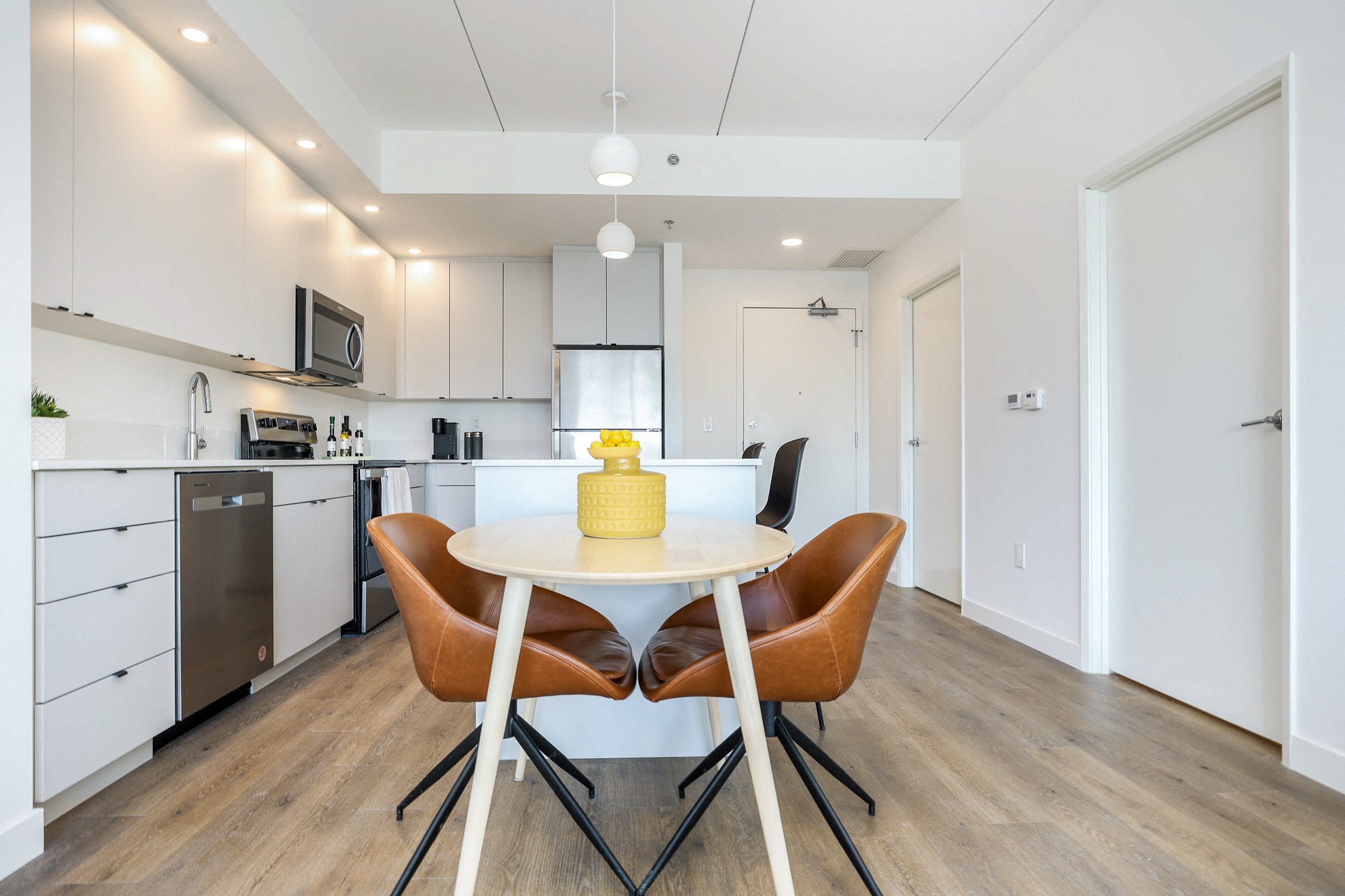 a kitchen and dining room with a table and chairs