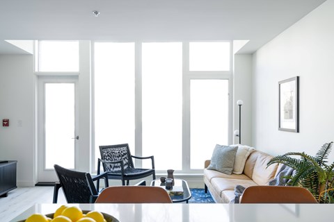 A living room with a couch, chair, and table.