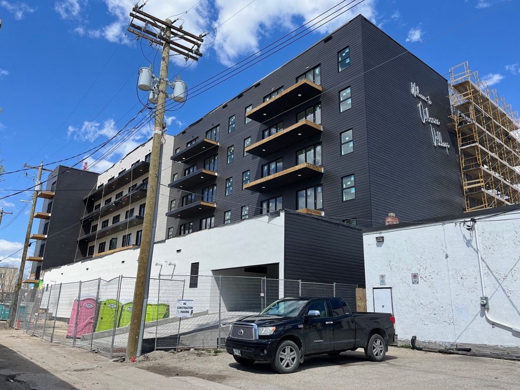 a black and white building with a truck parked in front