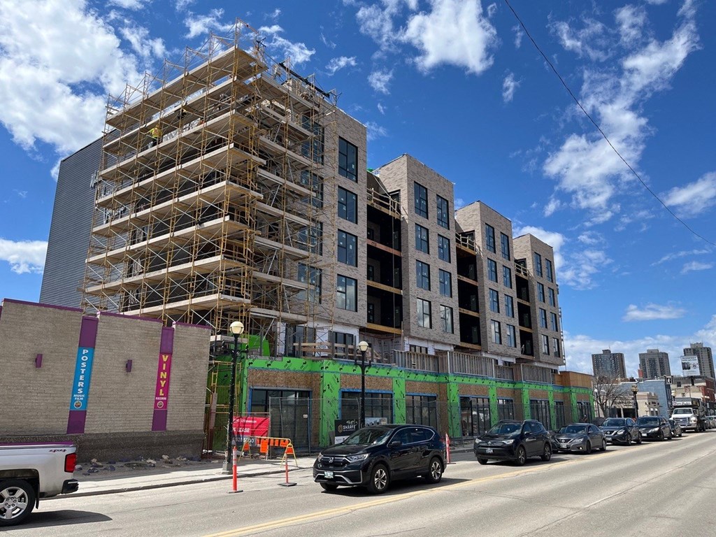 a building under construction on the corner of a city street