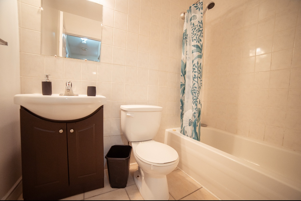 A white toilet sits next to a sink in a bathroom.