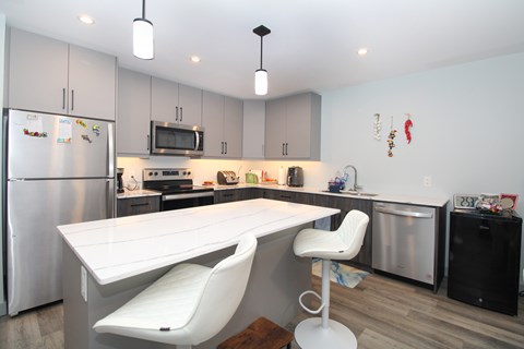 A modern kitchen with a white table and chairs.