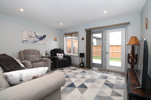 A living room with a grey couch and a checkered floor.