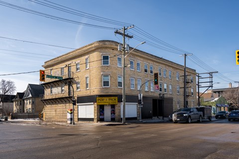 A street view of a building with a sign that says "Pop. Pick".