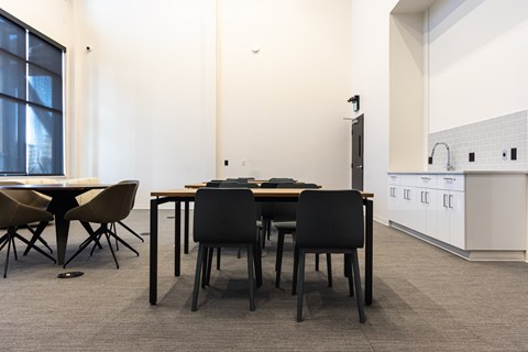 A modern dining room with a table and chairs.
