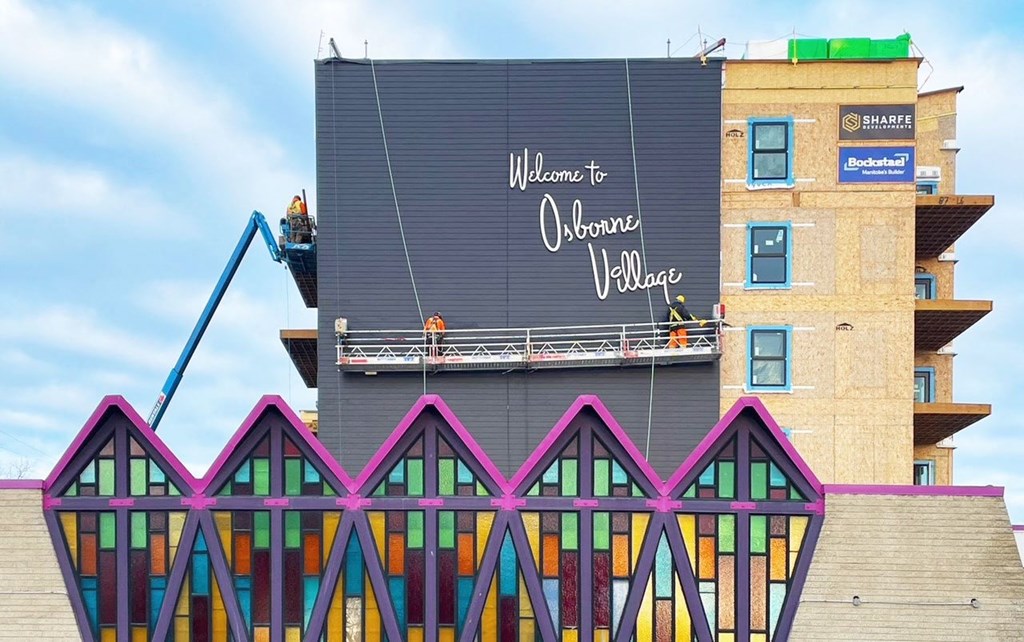 a mural being painted on the side of a building