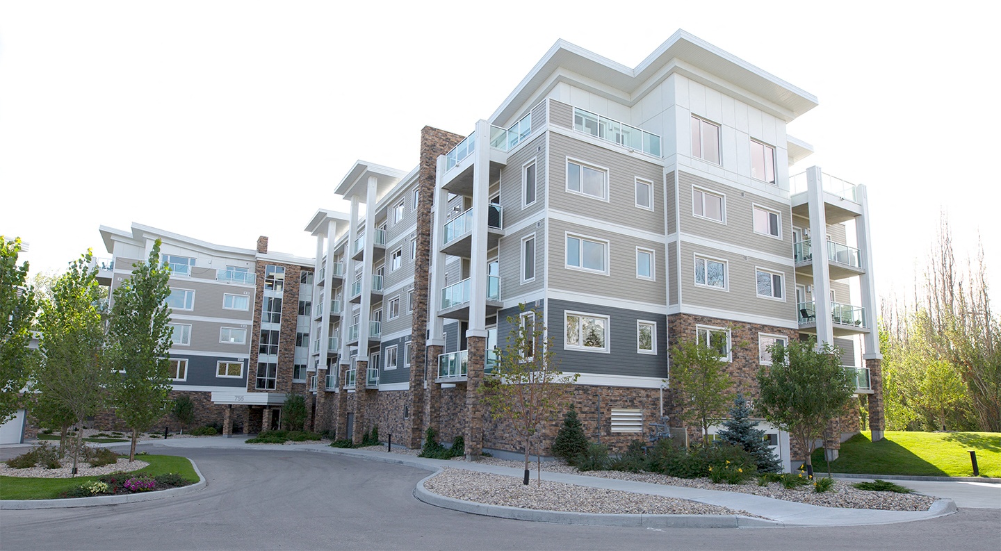 an exterior view of an apartment building on a street