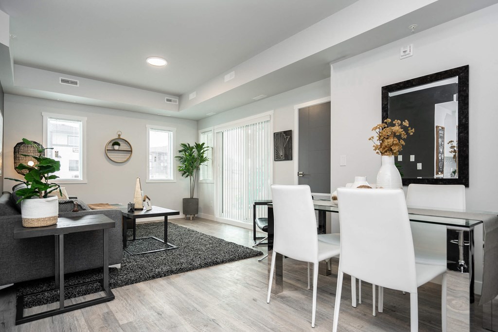a dining room and living room with a table and chairs