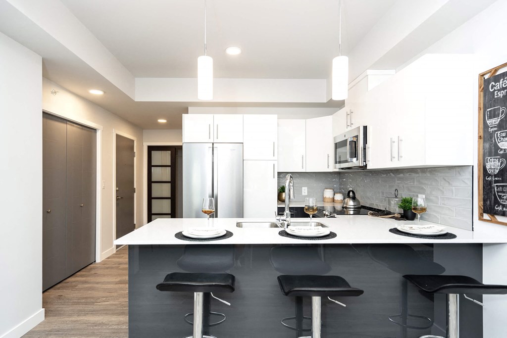 a kitchen with white cabinets and a white counter top