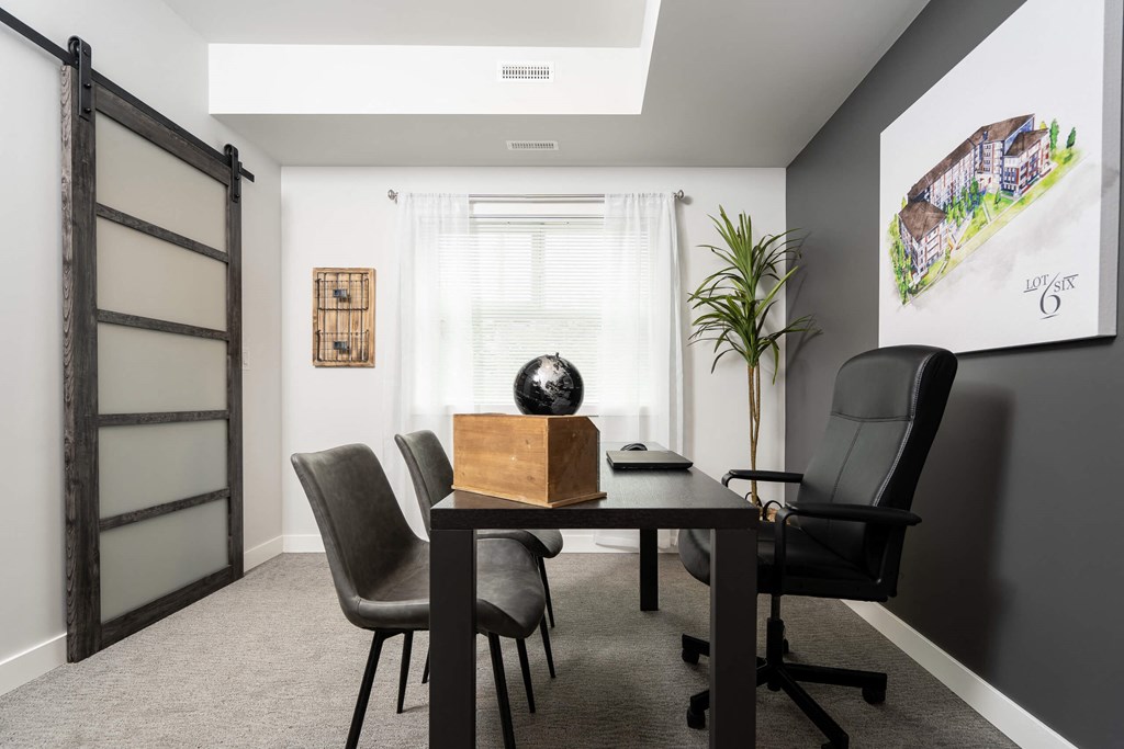 a dining room with a table and chairs
