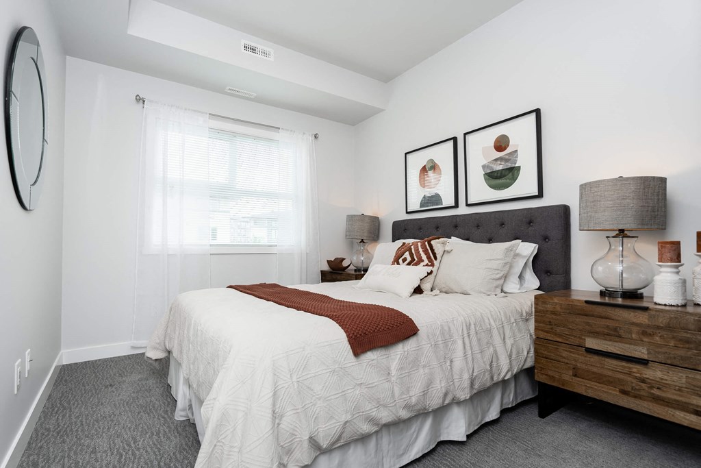 a bedroom with a large bed and a large window