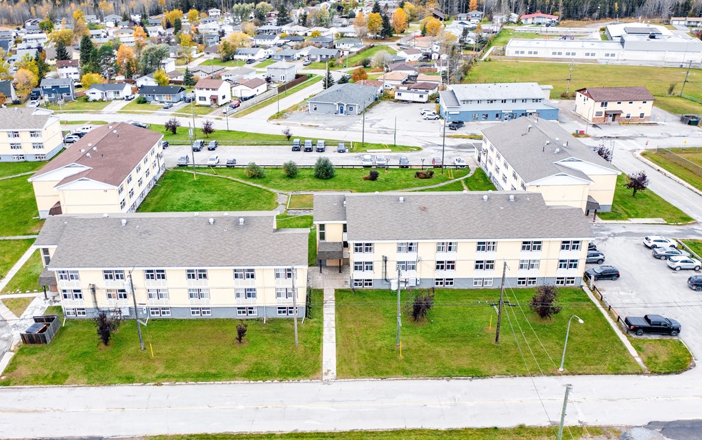 A large building complex with a parking lot in front.