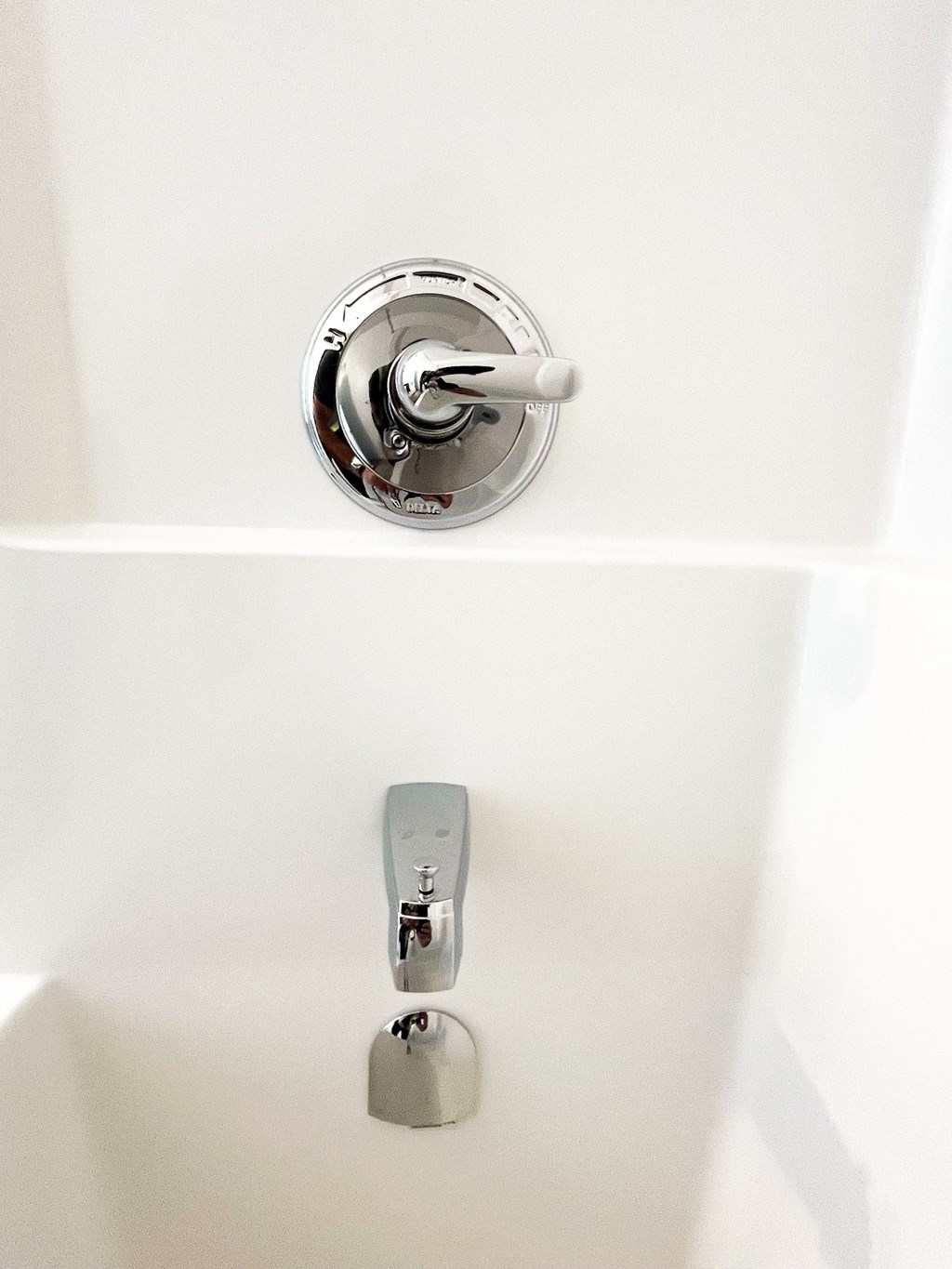 a white sink with a silver faucet in a bathroom