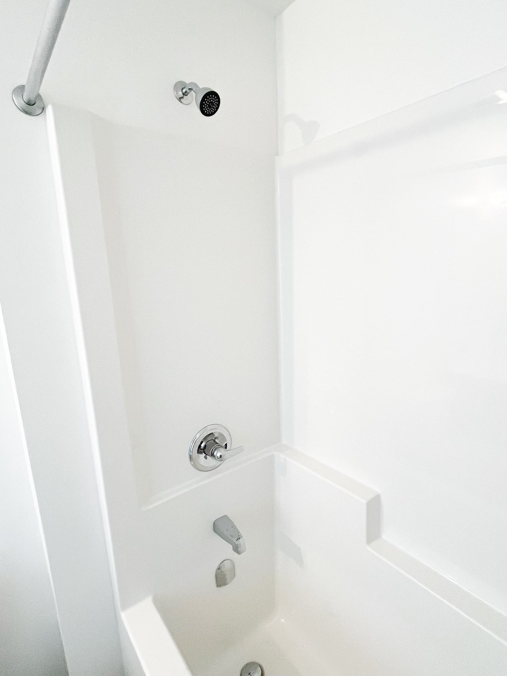 a small bathroom with a shower and a sink