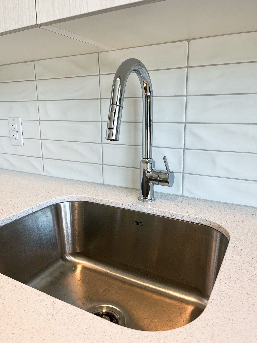 a kitchen sink with a faucet above it