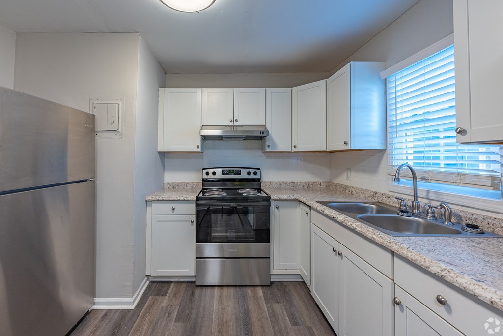 an empty kitchen with granite counter tops and stainless steel appliances