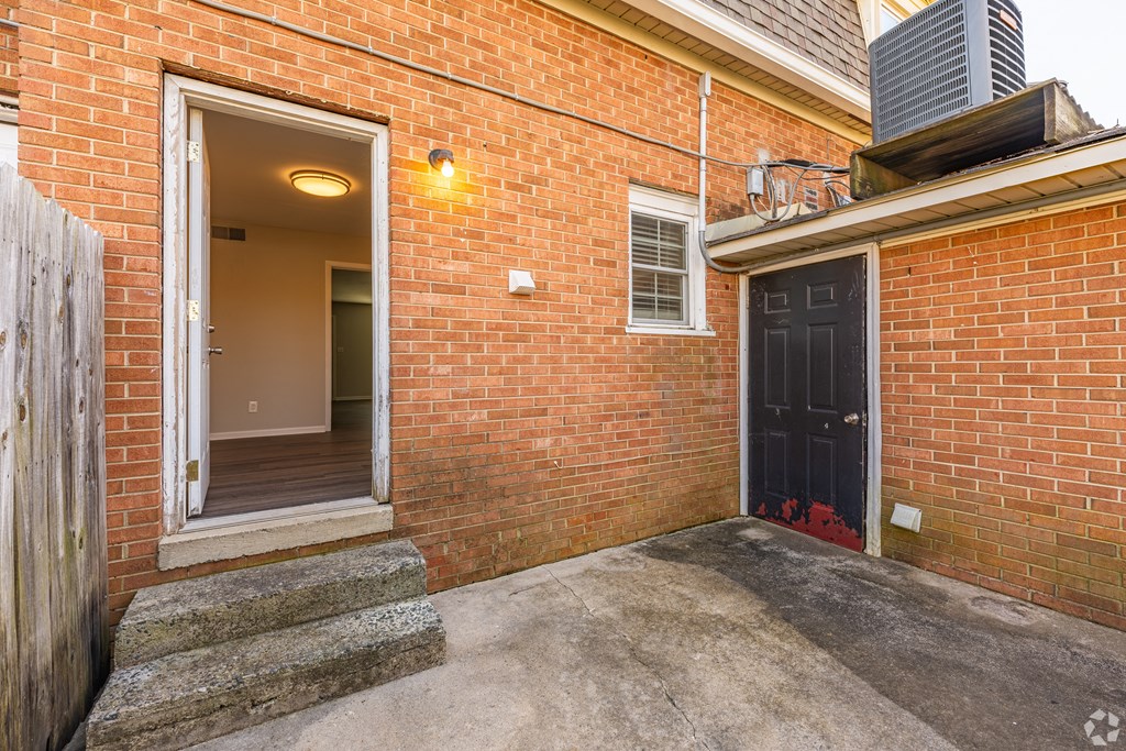the entrance to a brick building with a black door