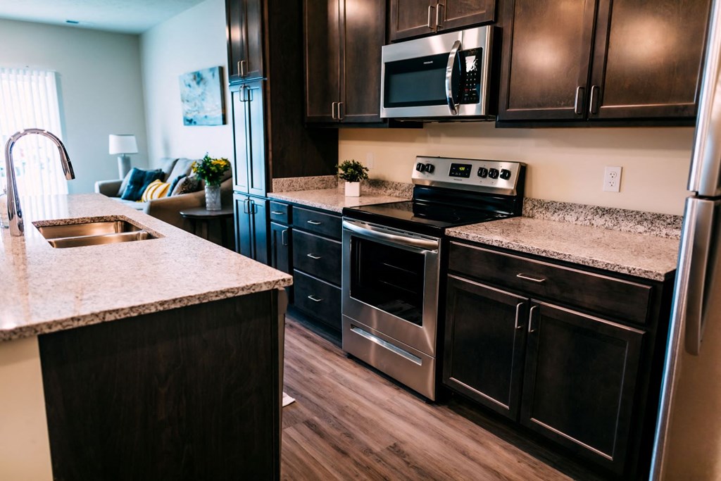 a kitchen with stainless steel appliances and granite counter tops