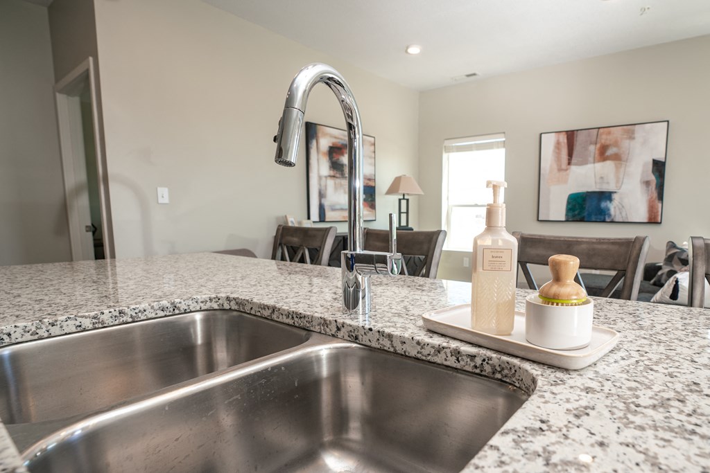 a kitchen counter with a sink and a faucet