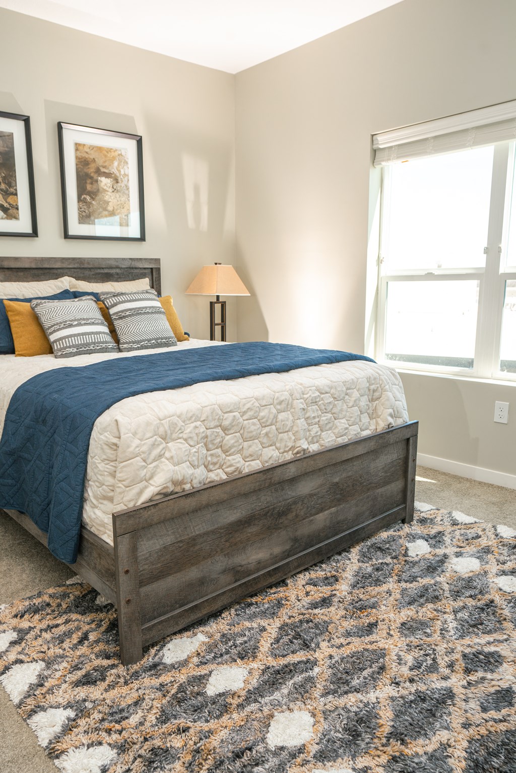 a bedroom with a bed and a rug