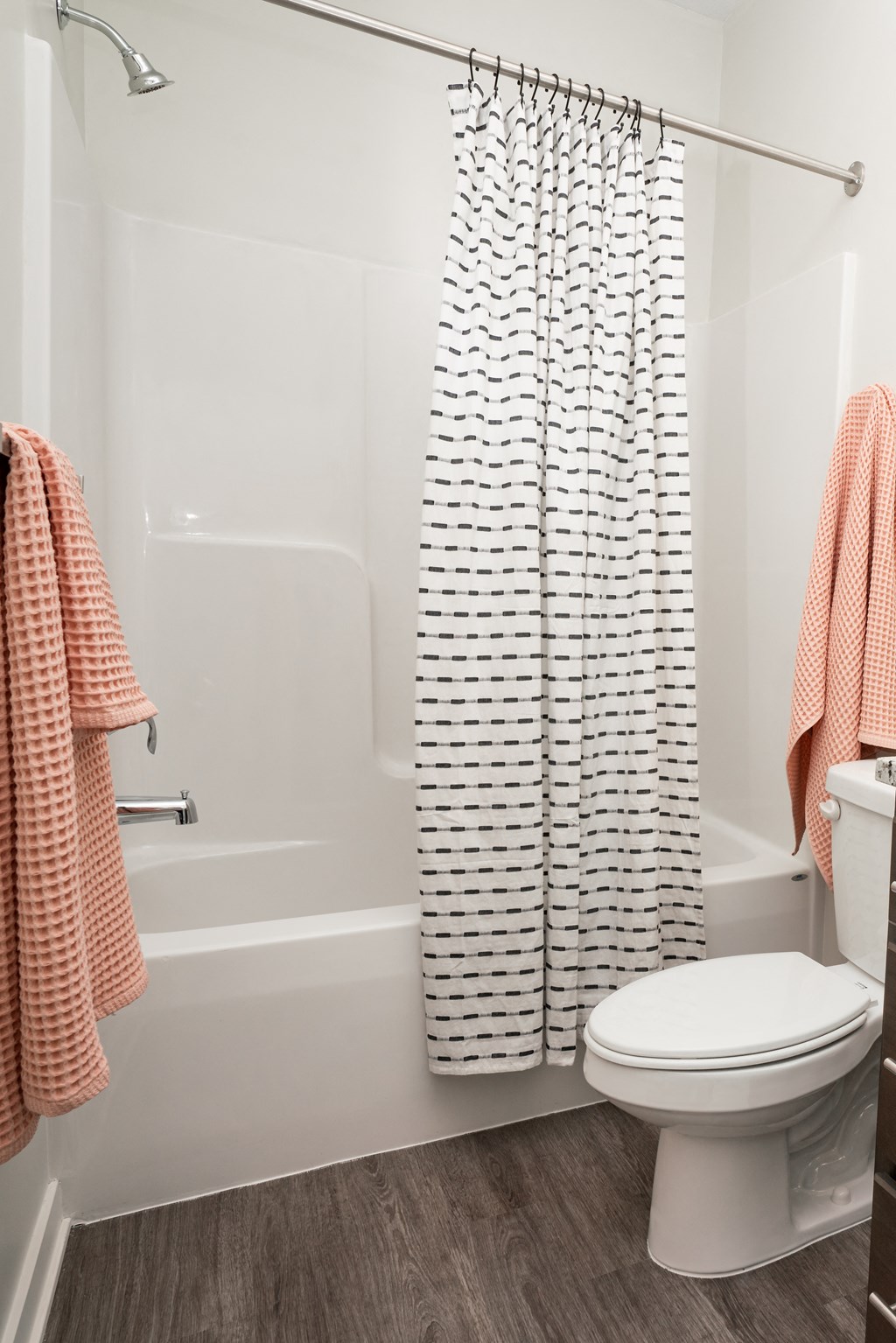 a bathroom with a toilet and a shower with a shower curtain