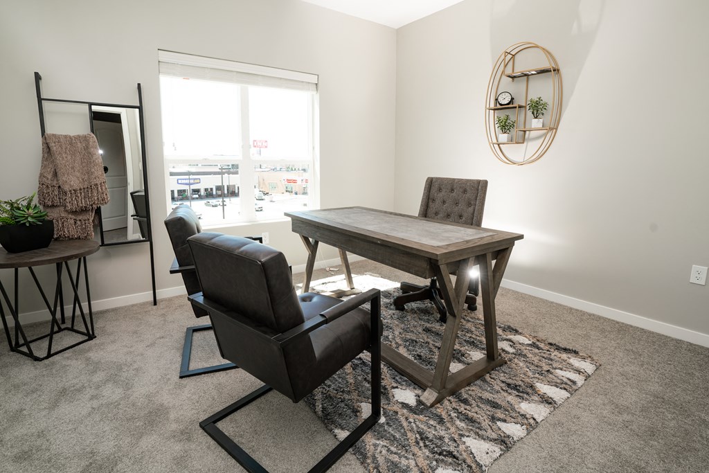 a dining room with a table and chairs and a window