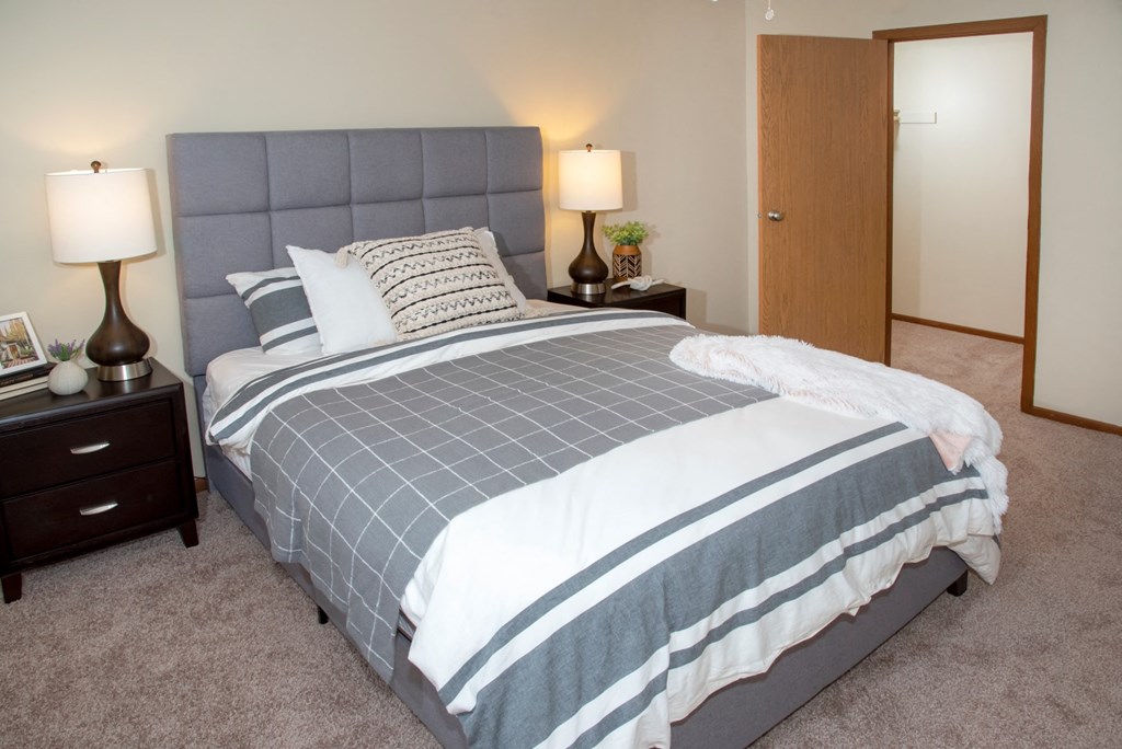 a bedroom with a bed and a closet