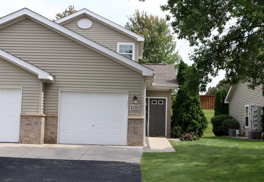 exterior of 1 bedroom single car garage townhome and private entry