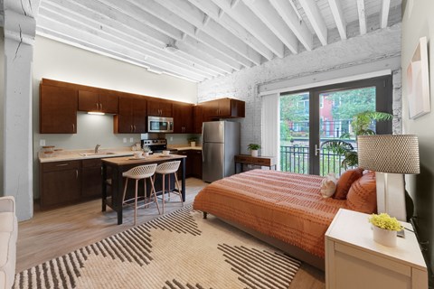 A bedroom with a bed, desk, and chair.