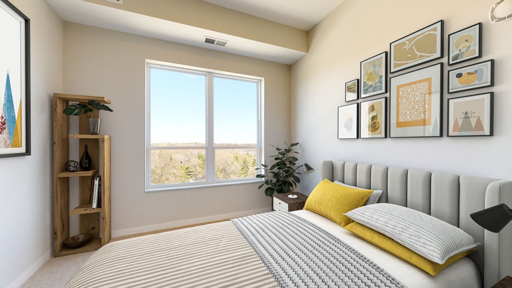 a bedroom with a large window and framed pictures on the wall