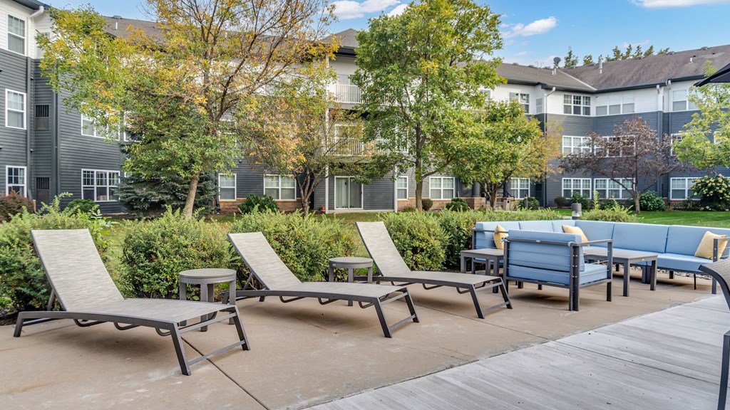 A sunny day at the outdoor seating area of a modern apartment complex.