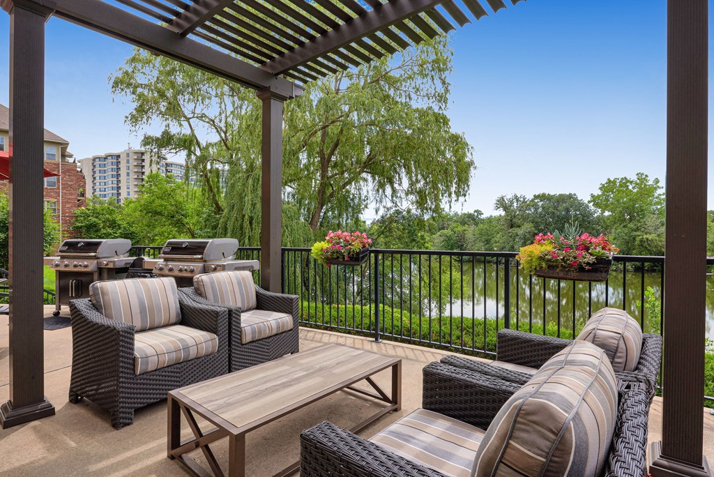 a patio with furniture and a view of a river