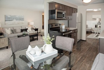 one plus den model, upgraded kitchen with slate cabinetry, vinyl flooring, dining area - Photo Gallery 4