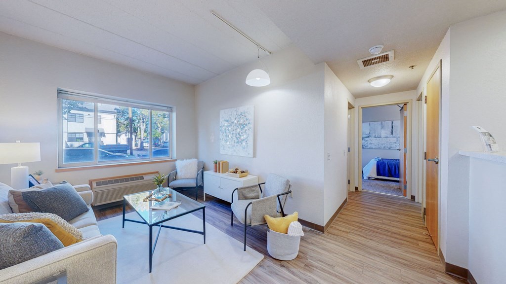 a living room with a couch and a table and a bedroom at Bierman Place, Minneapolis, 55414