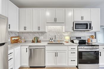 A modern kitchen with stainless steel appliances at Lochner Apartments, MN, 55110