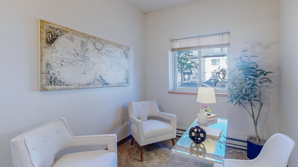 a living room with white chairs and a table and a window at Bierman Place, Minneapolis, MN