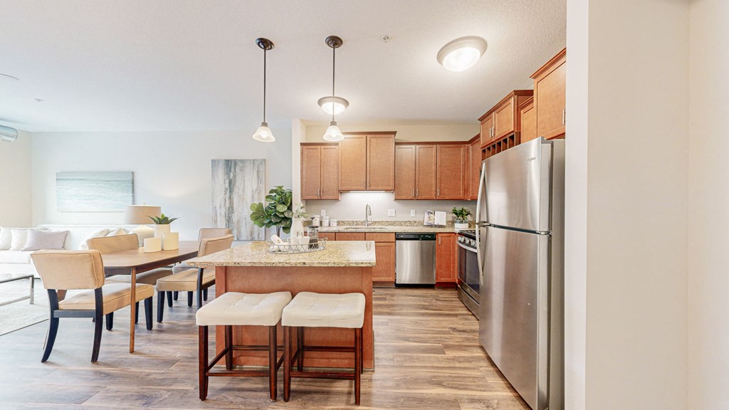 a kitchen and dining room with stainless steel appliances and wooden cabinets at Victoria Flats, Victoria, Minnesota