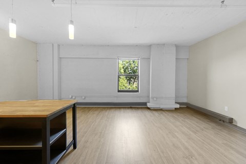 A room with a wooden table and a window.