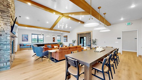 A dining room with a long table and chairs.