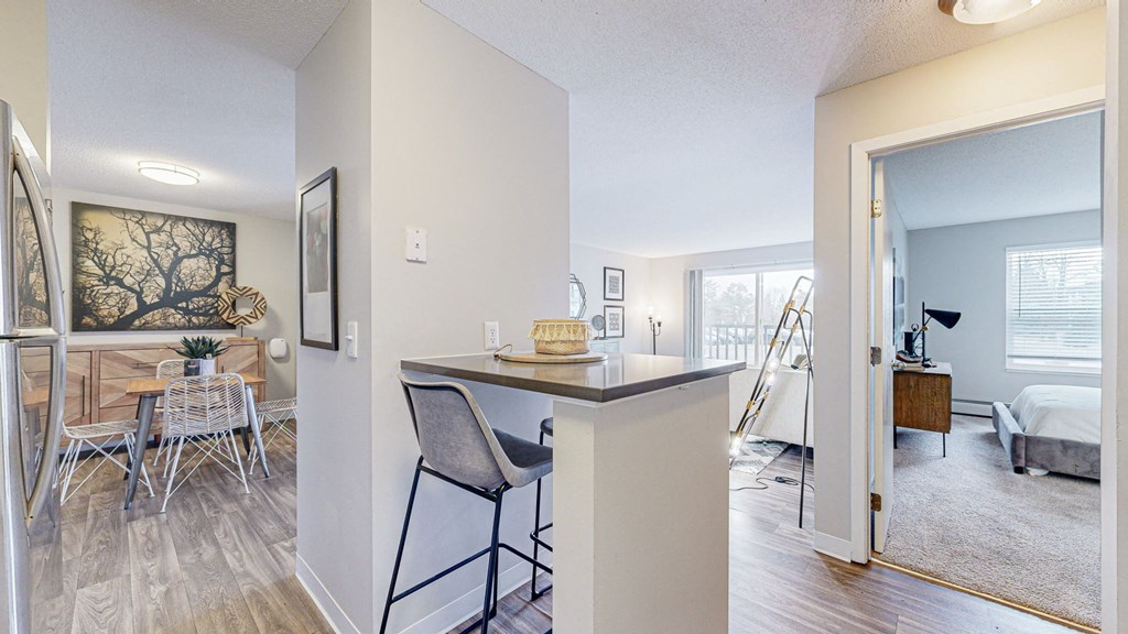 a living room with a bar and a dining room