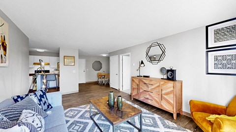 A living room with a yellow chair and a wooden coffee table.
