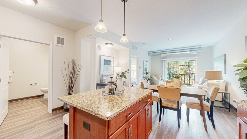 a kitchen with a granite counter top and a dining room table at Victoria Flats, Victoria, MN, 55386