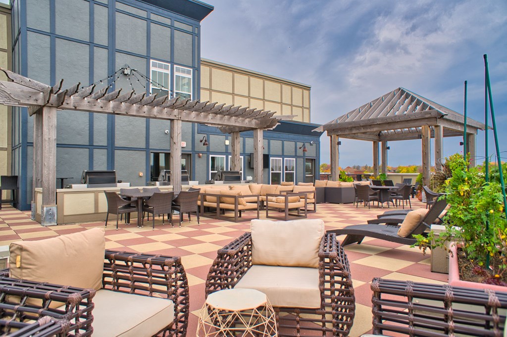 a rooftop patio with chairs and tables and grill stations at Victoria Flats, Victoria, MN
