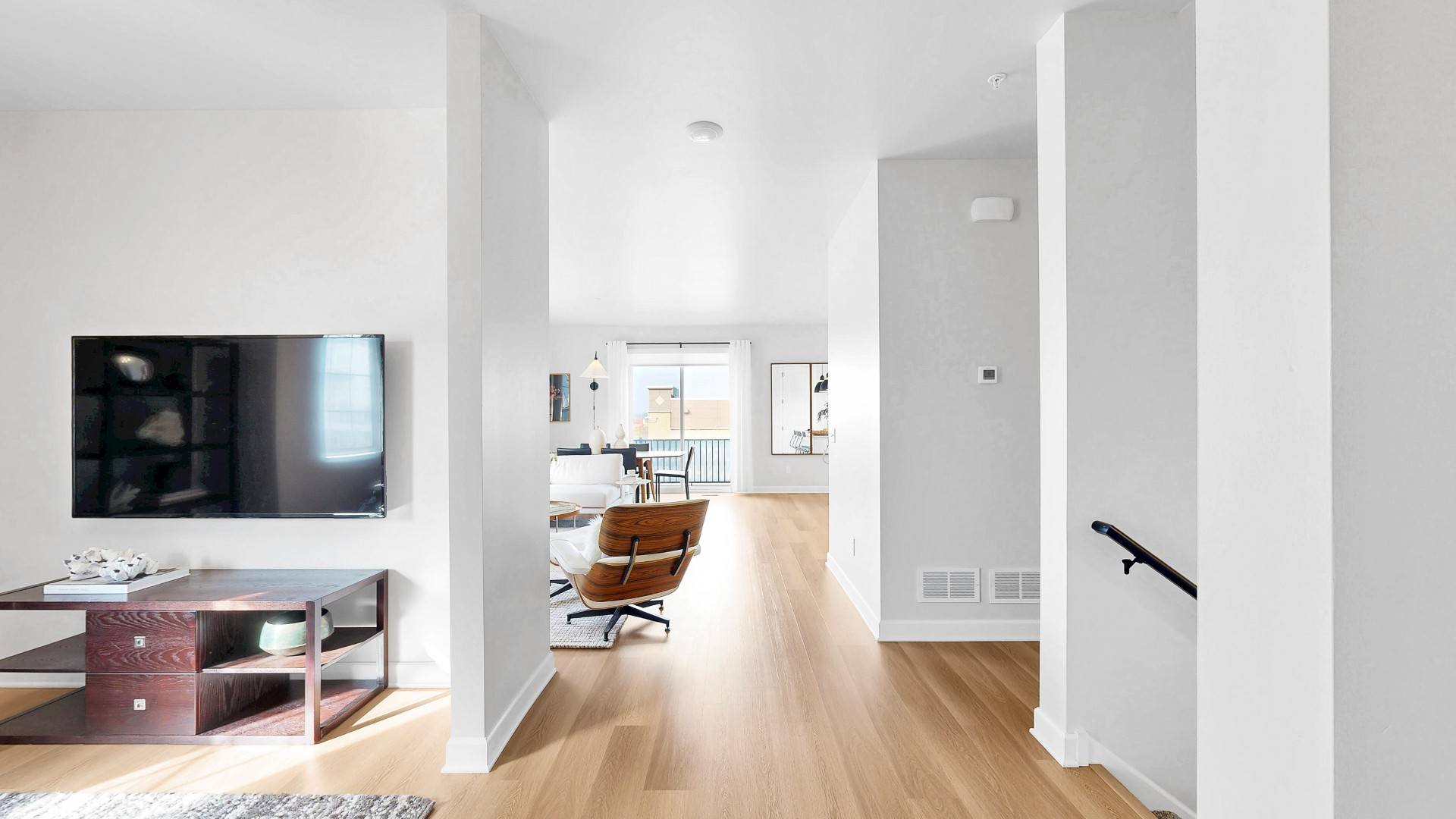 A modern living room with a television and a chair.
